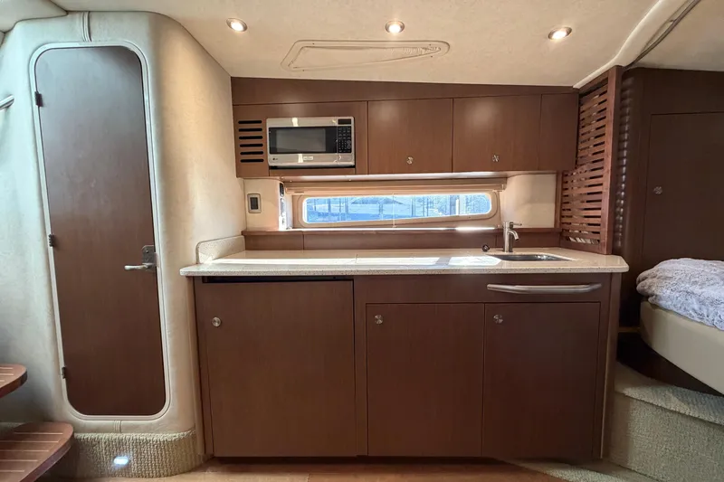 Slide: The Image of Interior of 2014 Sea Ray 370 Sundancer yacht with modern kitchen amenities. - 49