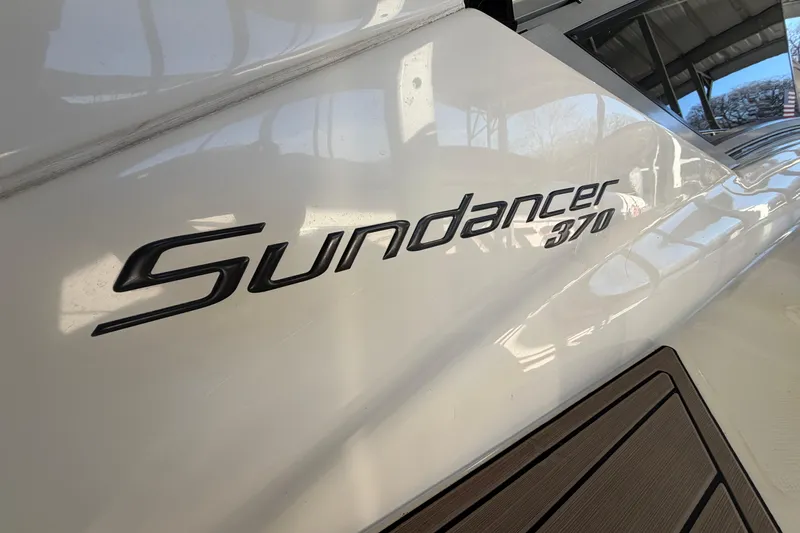Slide: The Image of 2014 Sea Ray 370 Sundancer boat logo on white hull. - 5