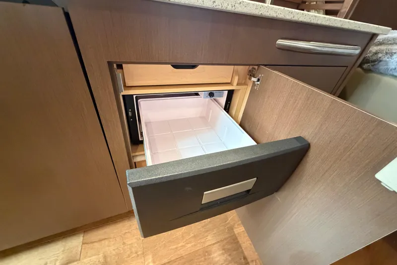 Slide: The Image of Open drawer in 2014 Sea Ray 370 Sundancer, showcasing interior storage space. - 53