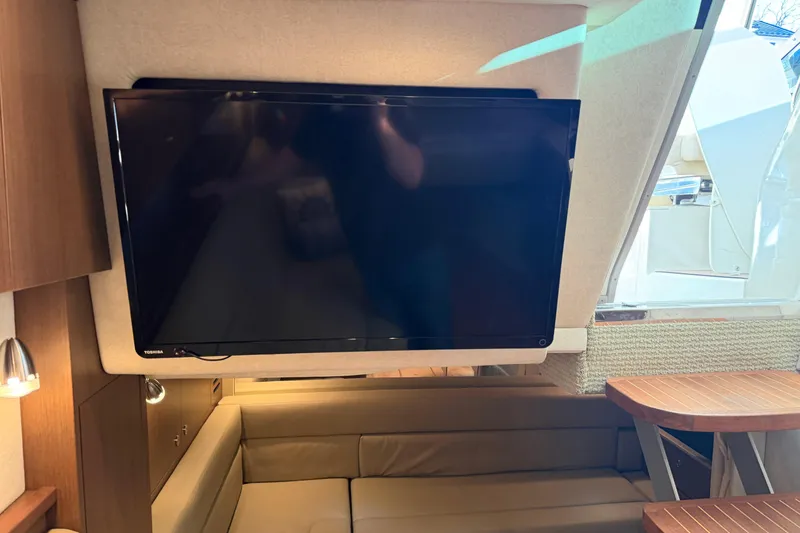 Slide: The Image of Interior of 2014 Sea Ray 370 Sundancer with TV and seating area. - 57