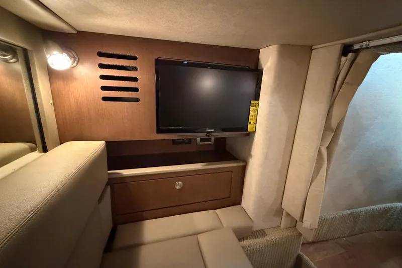 Slide: The Image of Interior of 2014 Sea Ray 370 Sundancer with TV and wooden cabinetry. - 59