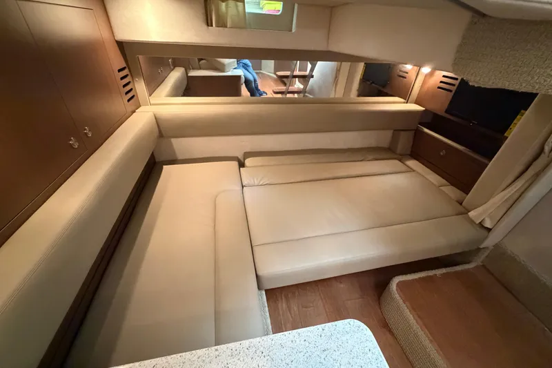 Slide: The Image of Interior of 2014 Sea Ray 370 Sundancer with beige seating and wooden accents. - 60