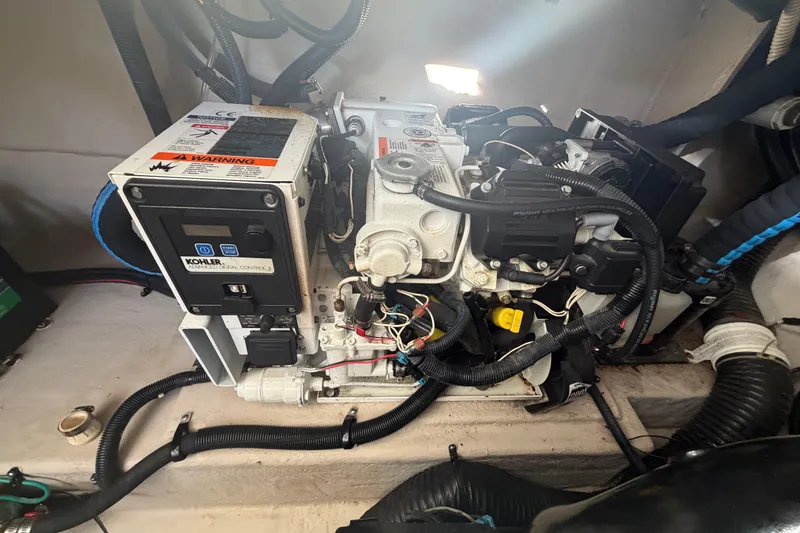 Slide: The Image of Engine compartment of 2014 Sea Ray 370 Sundancer with Kohler generator and wiring. - 67