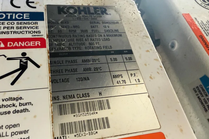 Slide: The Image of Kohler generator label on 2014 Sea Ray 370 Sundancer, showing specifications and safety warnings. - 69