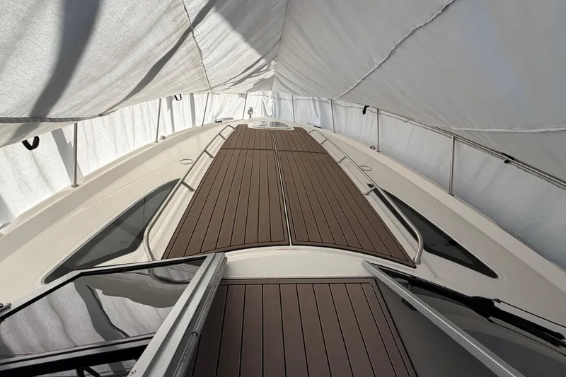 Slide: The Image of 2014 Sea Ray 370 Sundancer boat deck under protective cover. - 7