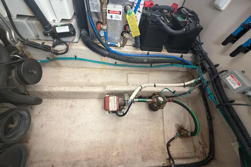 Slide: The Image of Engine compartment of a 2014 Sea Ray 370 Sundancer with visible wiring and components. - 70