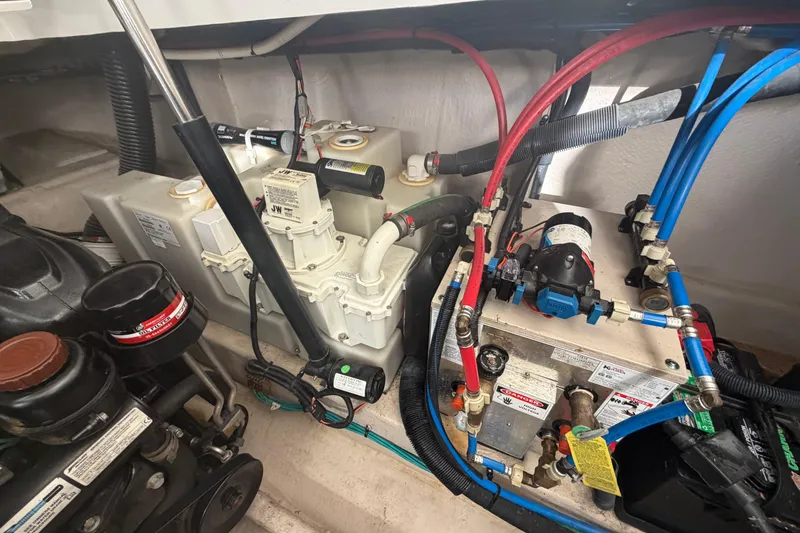 Slide: The Image of Engine compartment of a 2014 Sea Ray 370 Sundancer with visible mechanical components. - 71