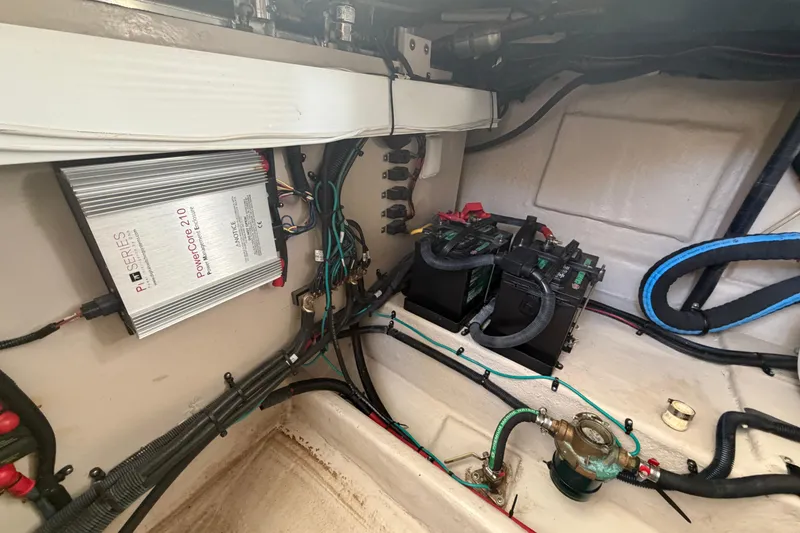 Slide: The Image of Engine compartment of a 2014 Sea Ray 370 Sundancer with batteries and wiring. - 73