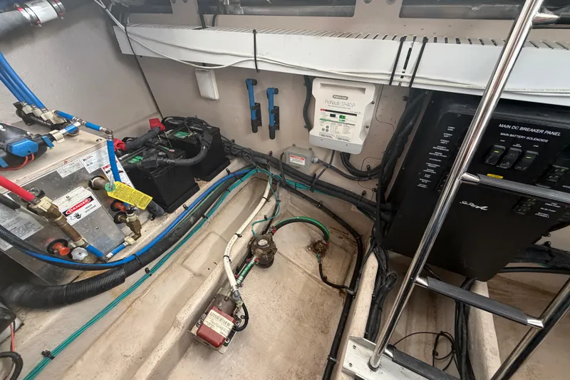 Slide: The Image of Engine room of 2014 Sea Ray 370 Sundancer with electrical components and wiring. - 74