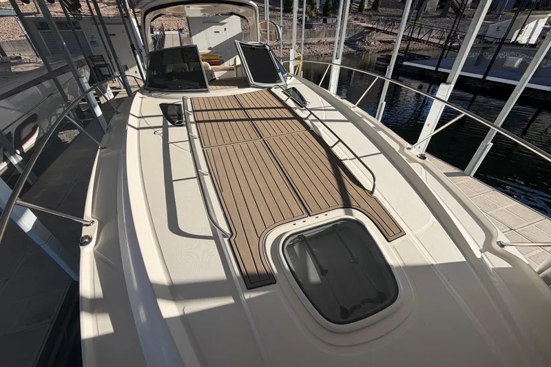 Slide: The Image of 2014 Sea Ray 370 Sundancer yacht with spacious deck and sleek design in marina. - 8