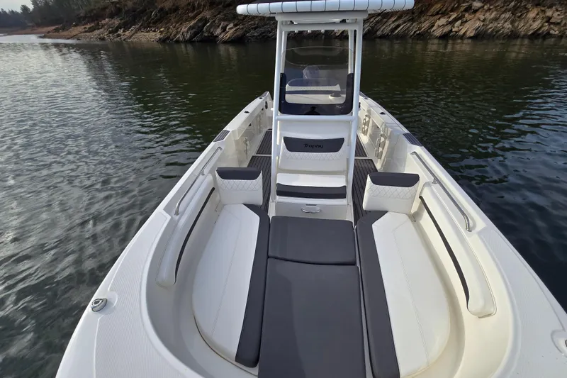 Slide: The Image of 2023 Bayliner Trophy T24CC boat interior with seating, on calm water. - 10