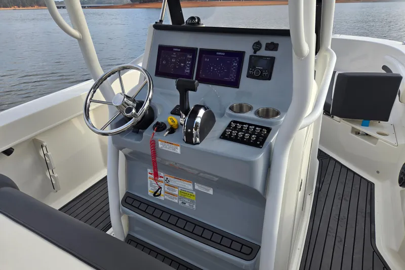 Slide: The Image of 2023 Bayliner Trophy T24CC boat helm with steering wheel and control panel. - 15