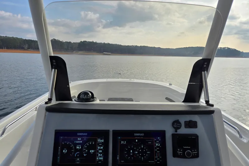 Slide: The Image of 2023 Bayliner Trophy T24CC dashboard view on calm waters. - 17