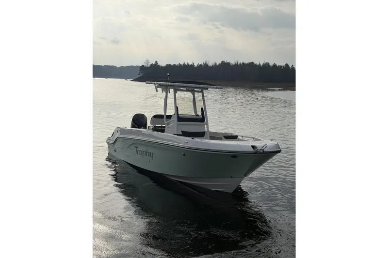 Slide: The Image of 2023 Bayliner Trophy T24CC boat on calm water under cloudy sky. - 8