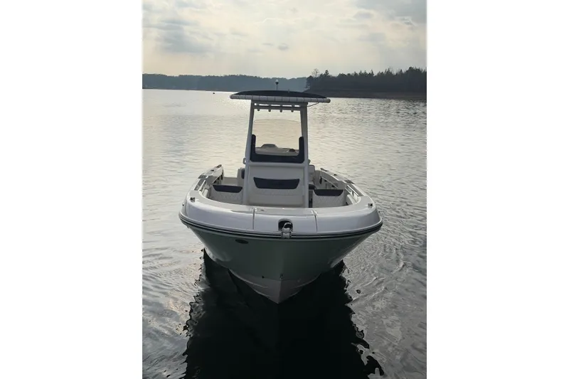 Slide: The Image of 2023 Bayliner Trophy T24CC boat on calm water, front view. - 9