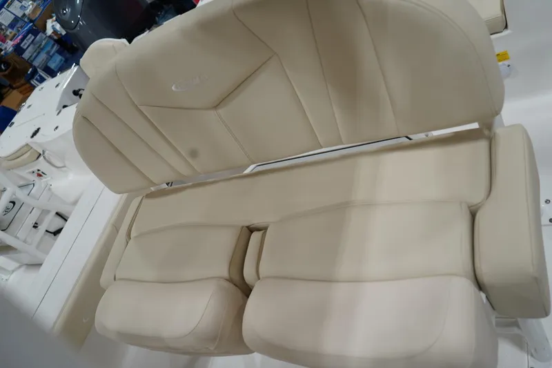 Slide: The Image of 2026 Robalo 226 Cayman boat with beige cushioned seating, showcasing luxury and comfort. - 11