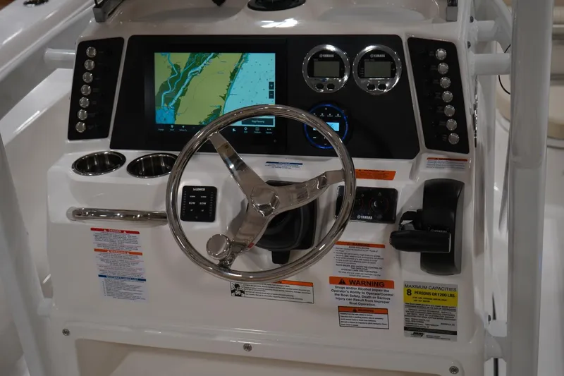 Slide: The Image of 2026 Robalo 226 Cayman boat dashboard with navigation screen and controls. - 7