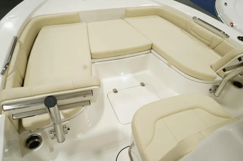 Slide: The Image of 2026 Robalo 226 Cayman boat interior with beige cushioned seating and stainless steel fixtures. - 8
