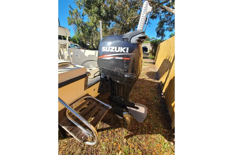 Slide: The Image of Outboard motor on 1994 Key West 1900 Sportsman boat, parked outdoors. - 14