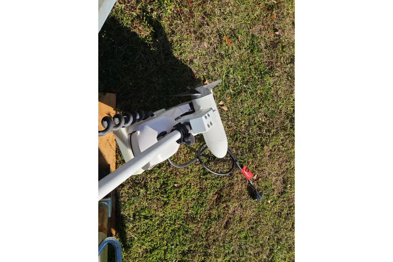 Slide: The Image of Trolling motor on grass, Key West 1900 Sportsman 1994 boat accessory. - 18