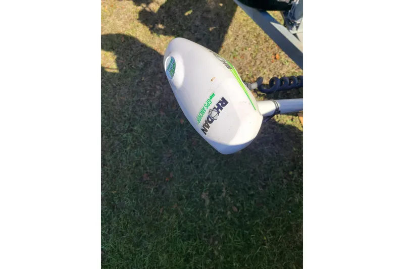 Slide: The Image of Outboard motor on 1994 Key West 1900 Sportsman boat, grass background. - 19