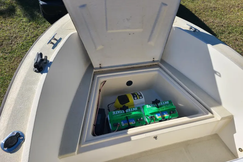Slide: The Image of Open storage compartment on 1994 Key West 1900 Sportsman boat, showing batteries and equipment. - 4