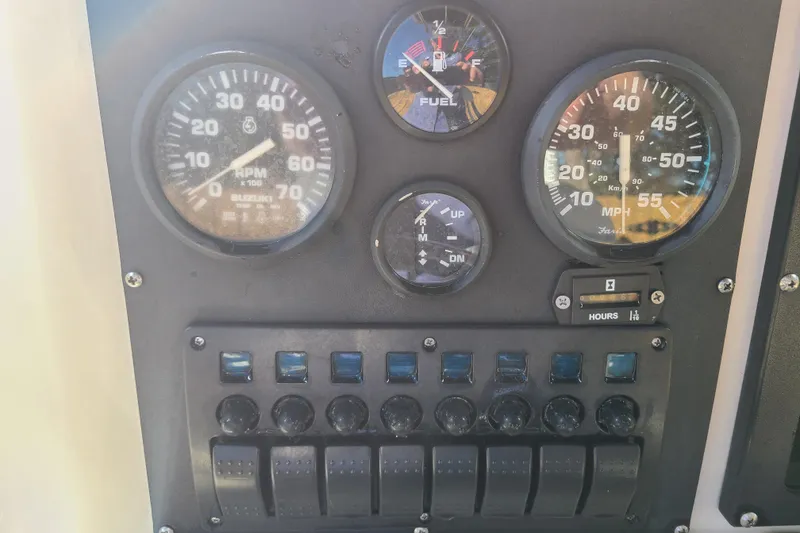 Slide: The Image of Dashboard of a 1994 Key West 1900 Sportsman boat with gauges and switches. - 7