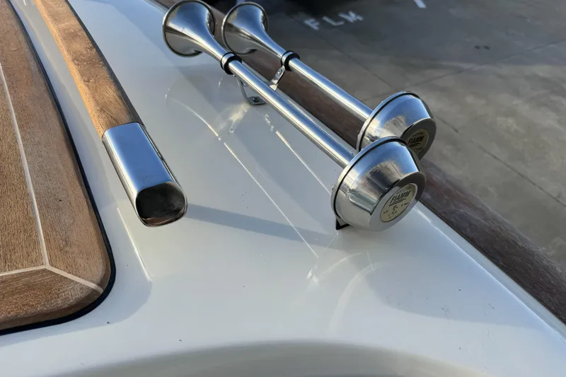 Slide: The Image of 2016 Chris-Craft Corsair 25 boat detail with chrome horns and wooden accents. - 10