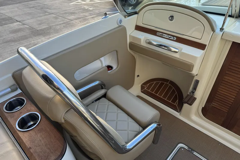 Slide: The Image of 2016 Chris-Craft Corsair 25 interior with beige seating and wood accents. - 21