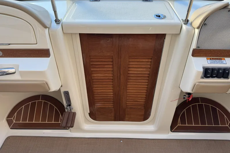 Slide: The Image of 2016 Chris-Craft Corsair 25 interior with wooden door and control panel. - 26