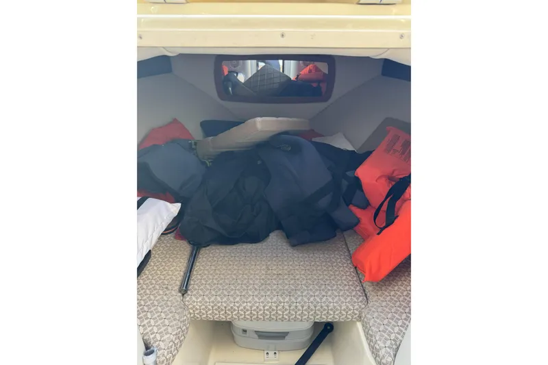 Slide: The Image of 2016 Chris-Craft Corsair 25 cabin interior with life jackets and gear. - 28