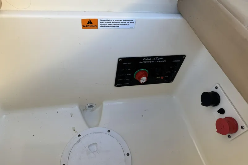 Slide: The Image of 2016 Chris-Craft Corsair 25 battery switch panel with warning label and controls. - 31