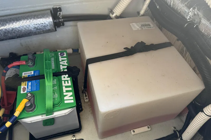 Slide: The Image of Battery compartment of a 2016 Chris-Craft Corsair 25 boat, featuring Interstate battery. - 36