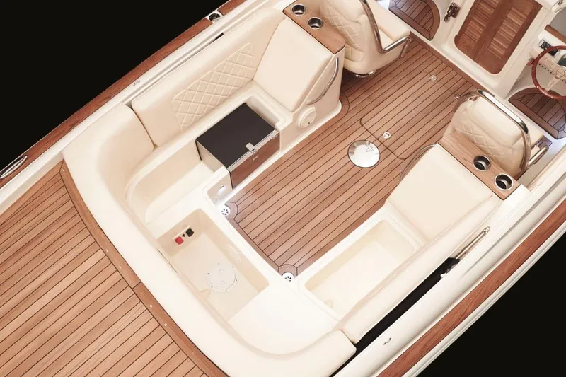 Slide: The Image of Manufacturer Provided Image: 2016 Chris-Craft Corsair 25 boat interior with luxurious seating and wooden deck. - 4