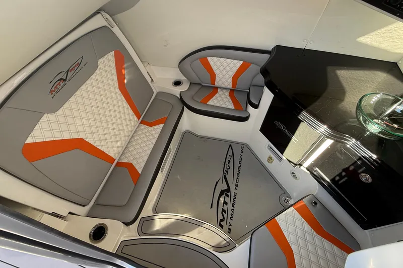 Slide: The Image of Interior of a 2017 MTI 42V boat with orange and gray seating. - 21
