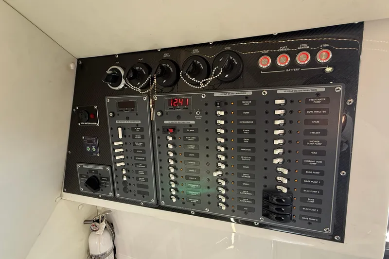 Slide: The Image of Control panel of a 2017 MTI 42V boat with switches and gauges. - 24