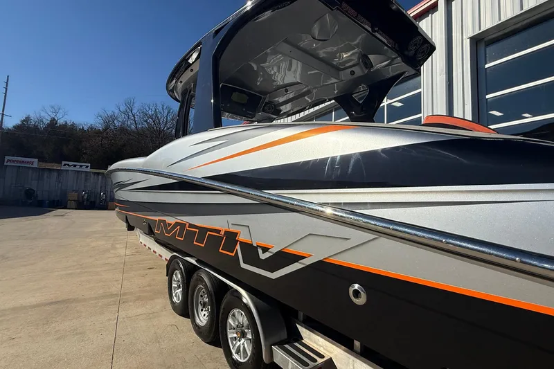 Slide: The Image of 2017 MTI 42V boat with sleek design and vibrant orange accents. - 8