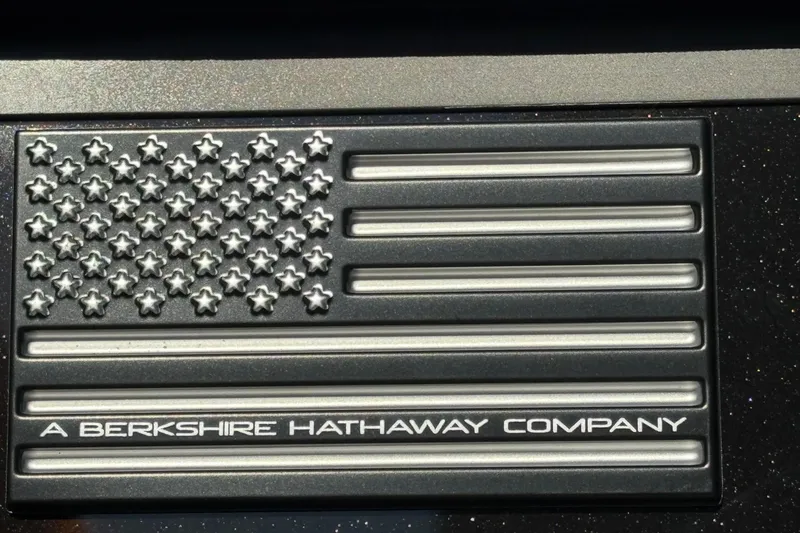 Slide: The Image of Metallic US flag emblem with Berkshire Hathaway inscription. - 11