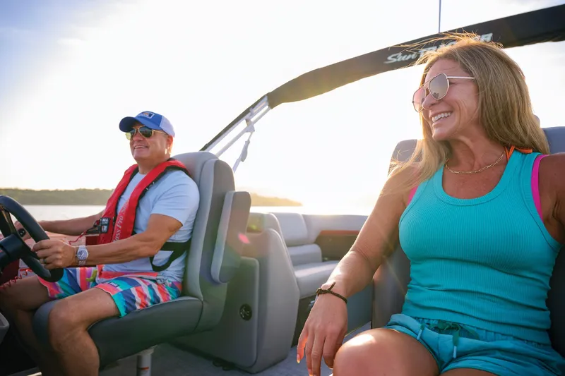 Slide: The Image of Manufacturer Provided Image: Couple enjoying a ride on a 2026 Sun Tracker Party Barge 22 DLX boat. - 16