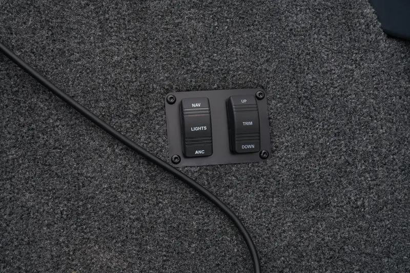 Slide: The Image of Manufacturer Provided Image: Manufacturer Provided Image: Control panel on Ranger VS1665SC 2025 boat, featuring navigation and trim switches. - 10