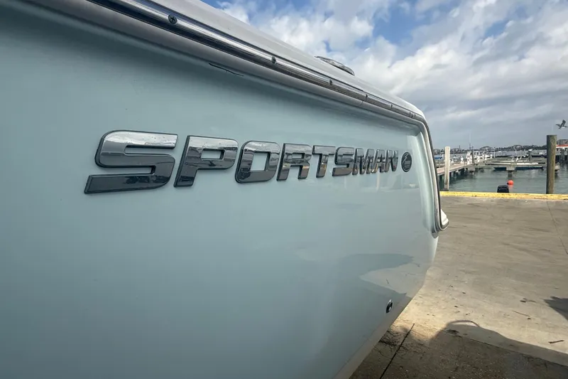 Slide: The Image of 2022 Sportsman Open 232 Center Console boat at a marina dockside. - 10