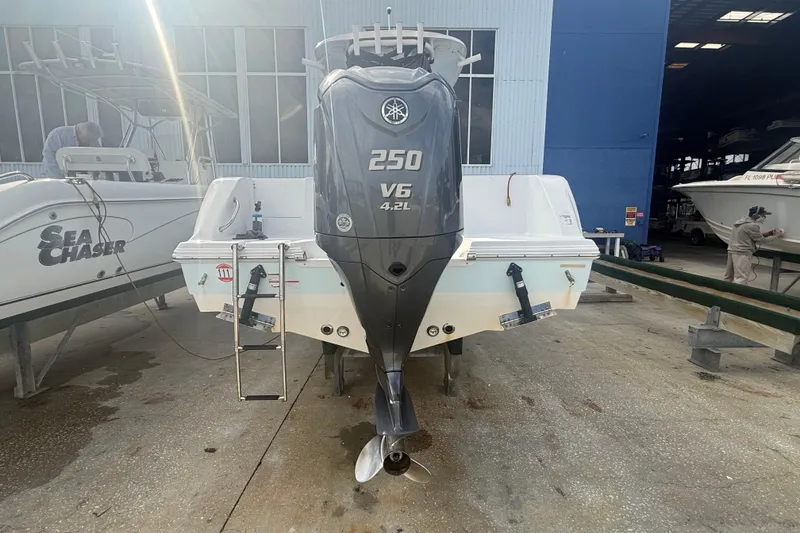 Slide: The Image of 2022 Sportsman Open 232 Center Console with Yamaha 250 V6 engine in a boatyard. - 13