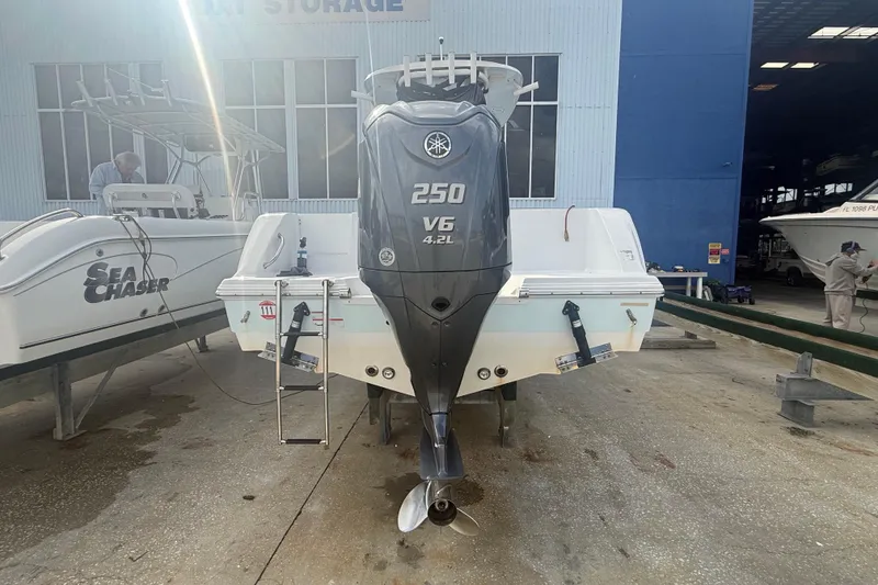 Slide: The Image of 2022 Sportsman Open 232 Center Console with Yamaha 250 V6 engine in boat storage. - 15