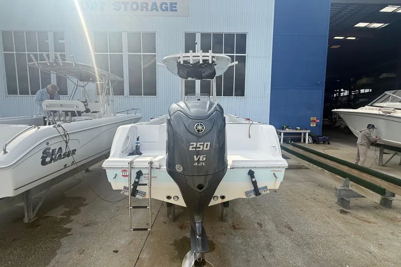 Slide: The Image of 2022 Sportsman Open 232 Center Console boat with Yamaha 250 V6 engine at storage facility. - 16