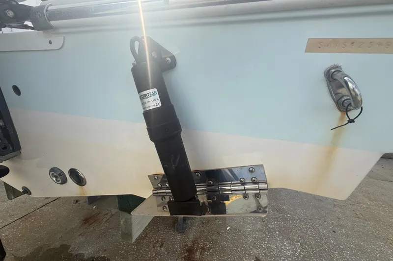 Slide: The Image of 2022 Sportsman Open 232 Center Console boat with trim tab and hydraulic actuator. - 17