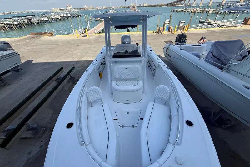 Slide: The Image of 2022 Sportsman Open 232 Center Console boat docked by the waterfront. - 22