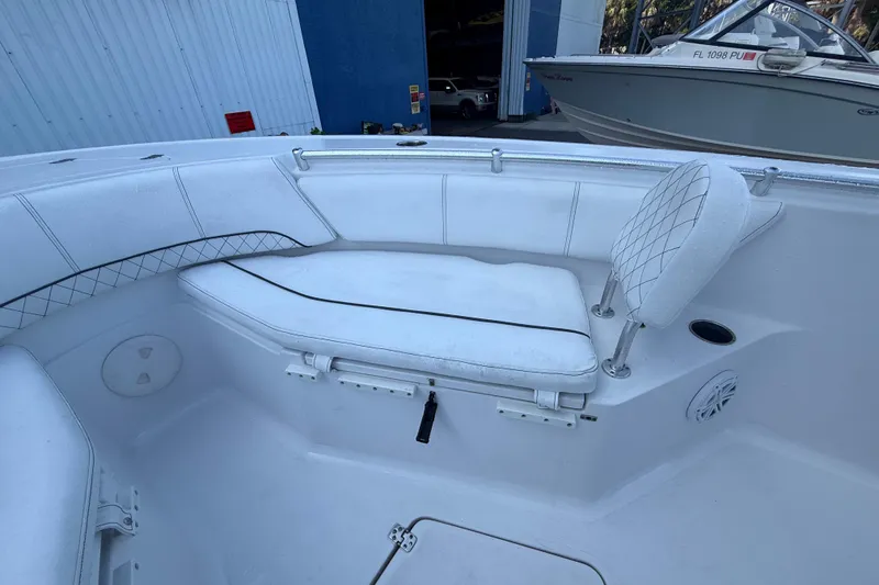 Slide: The Image of 2022 Sportsman Open 232 Center Console boat interior with white seating and storage. - 28