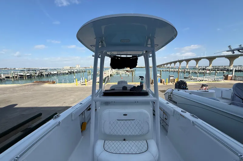 Slide: The Image of 2022 Sportsman Open 232 Center Console boat docked near marina with bridge view. - 31