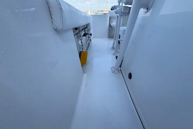 Slide: The Image of 2022 Sportsman Open 232 Center Console boat interior with fishing rod holders and seating. - 37