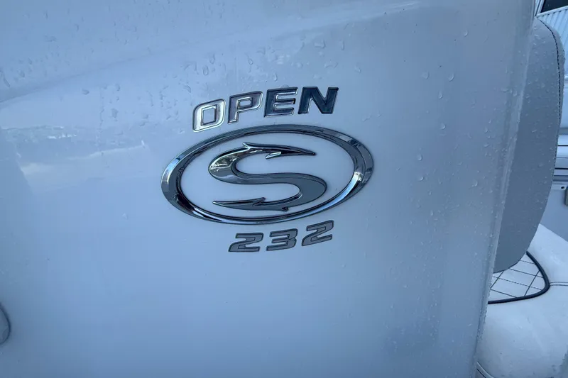 Slide: The Image of 2022 Sportsman Open 232 Center Console boat logo on white surface. - 38